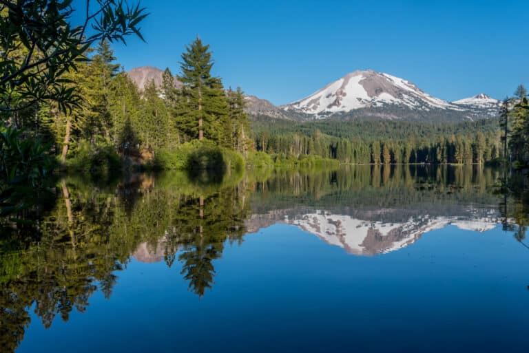 Lassen Peak reflected in Manzanita Lake in the Volcanic National Park in summer.